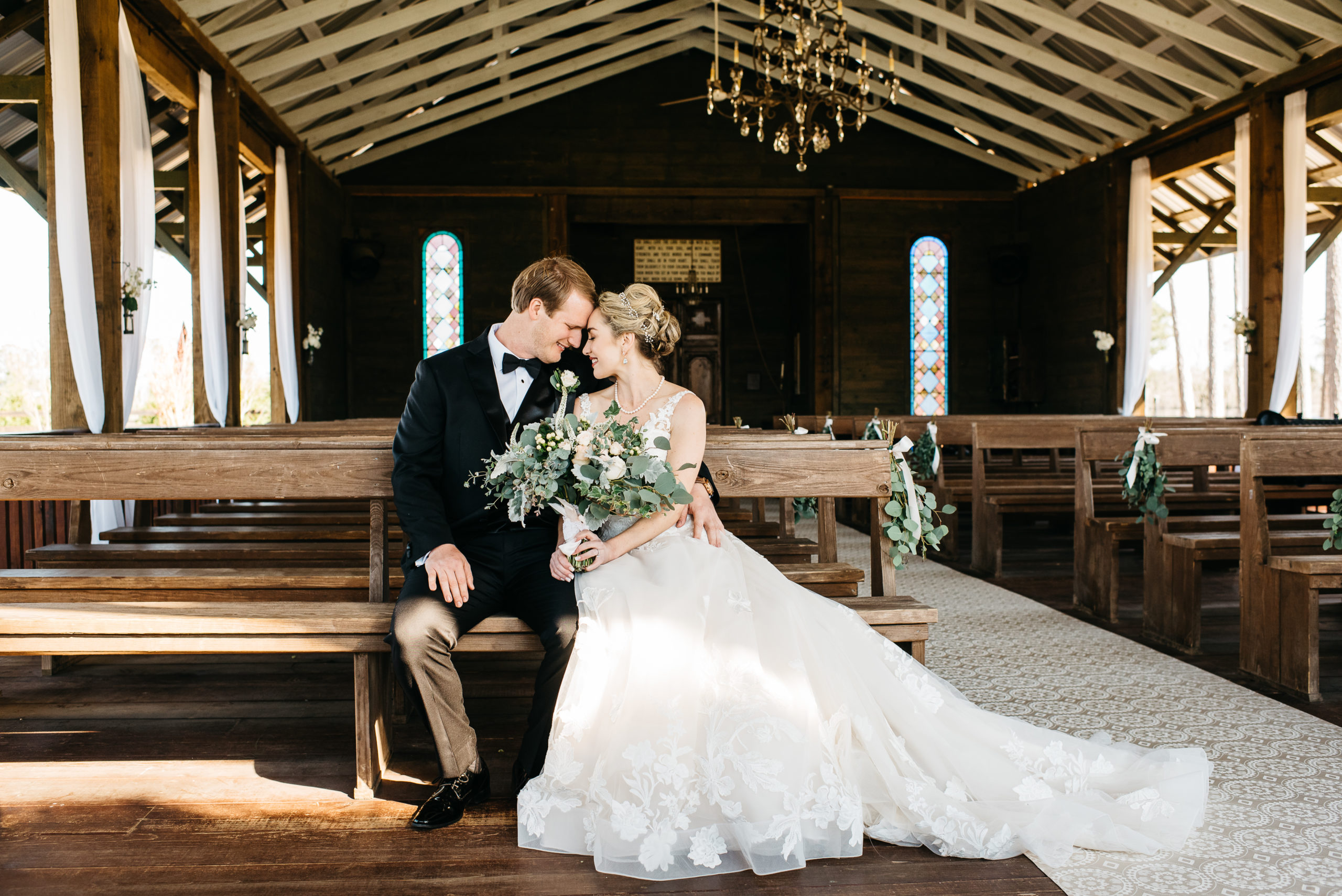 Bride and groom sit together in chapel at pine knoll farms appling ga