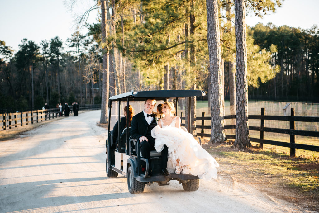 bride and groom in golf cart at pine knoll farms 