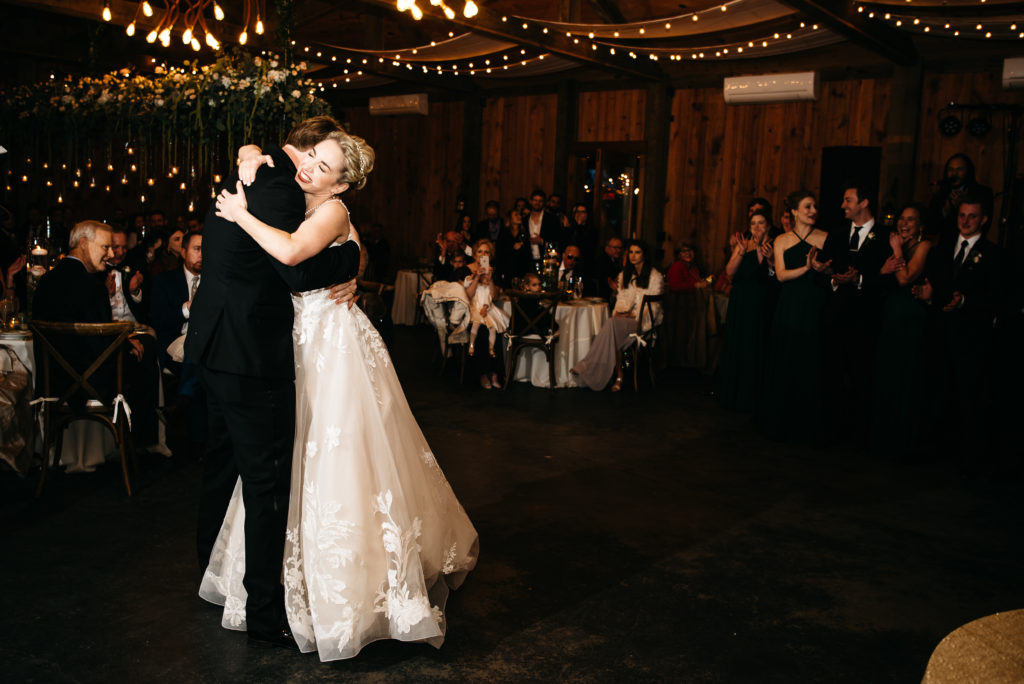 bride and groom hug after first dance at pine knoll farms appling, ga 