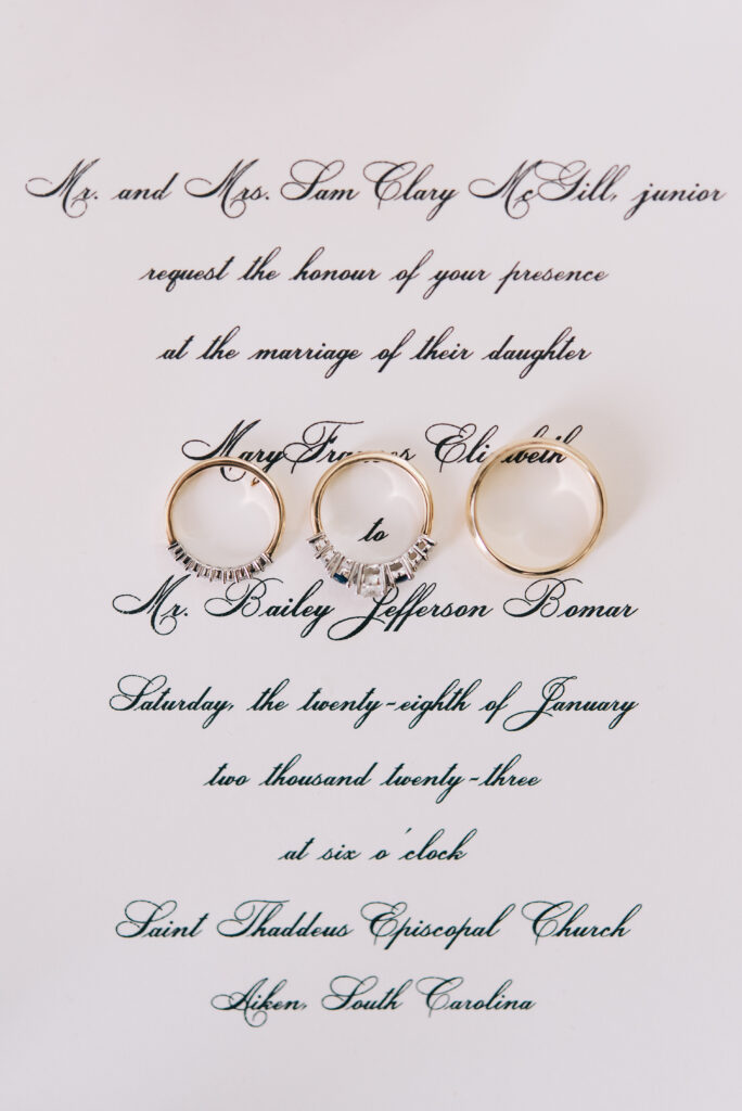 invitation and rings on wedding at the willcox aiken sc
