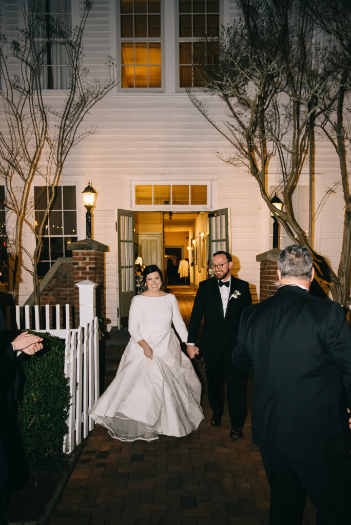 bride and groom entering reception at the willcox in Aiken SC 
wedding photographer